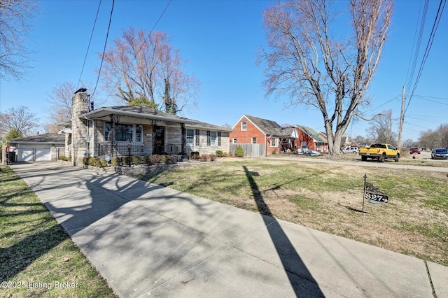 view of front of house featuring fence, covered porch, a front yard, a garage, and a chimney