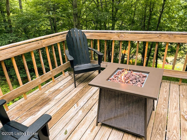 wooden deck featuring a fire pit