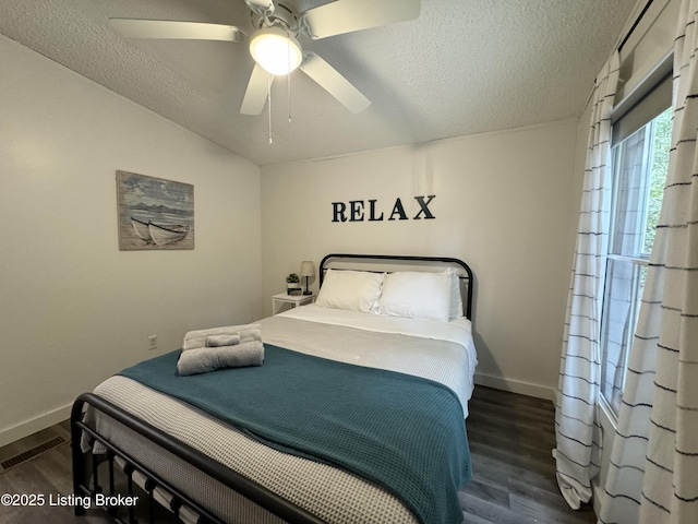 bedroom featuring wood finished floors, baseboards, and a textured ceiling