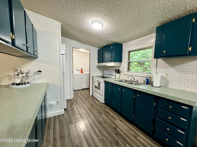 kitchen with electric stove, a sink, light countertops, dark wood-style flooring, and washing machine and clothes dryer