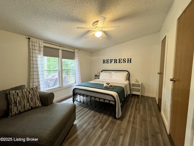 bedroom with a textured ceiling, wood finished floors, baseboards, ceiling fan, and vaulted ceiling