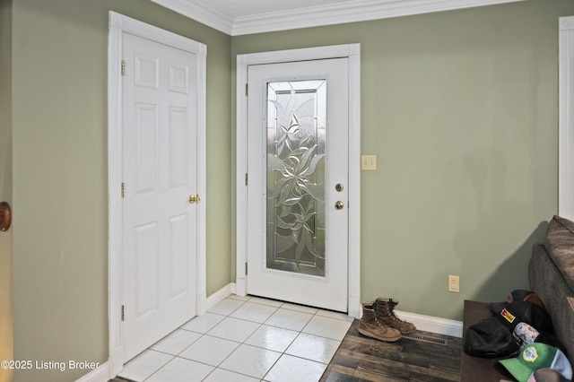 foyer featuring light tile patterned flooring, baseboards, and ornamental molding