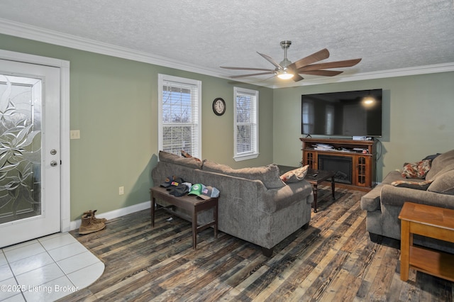 living room featuring a textured ceiling, crown molding, wood finished floors, and ceiling fan