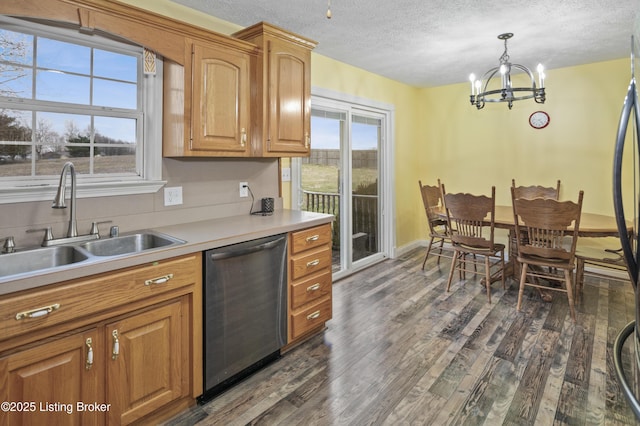 kitchen with a chandelier, a wealth of natural light, dark wood-style flooring, stainless steel dishwasher, and a sink