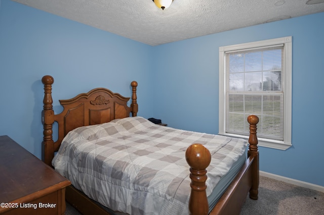 bedroom featuring carpet flooring, baseboards, and a textured ceiling