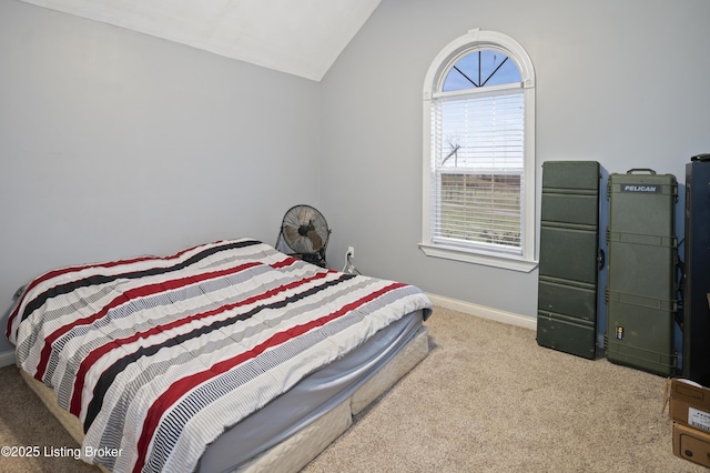 bedroom featuring baseboards, lofted ceiling, and carpet floors