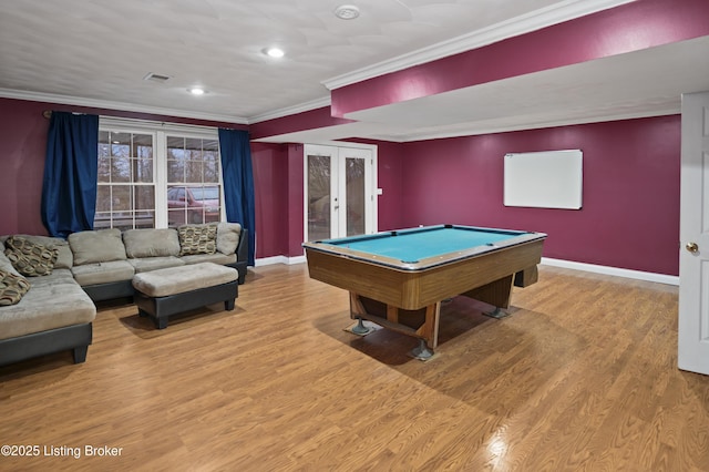 recreation room with crown molding, wood finished floors, visible vents, and baseboards