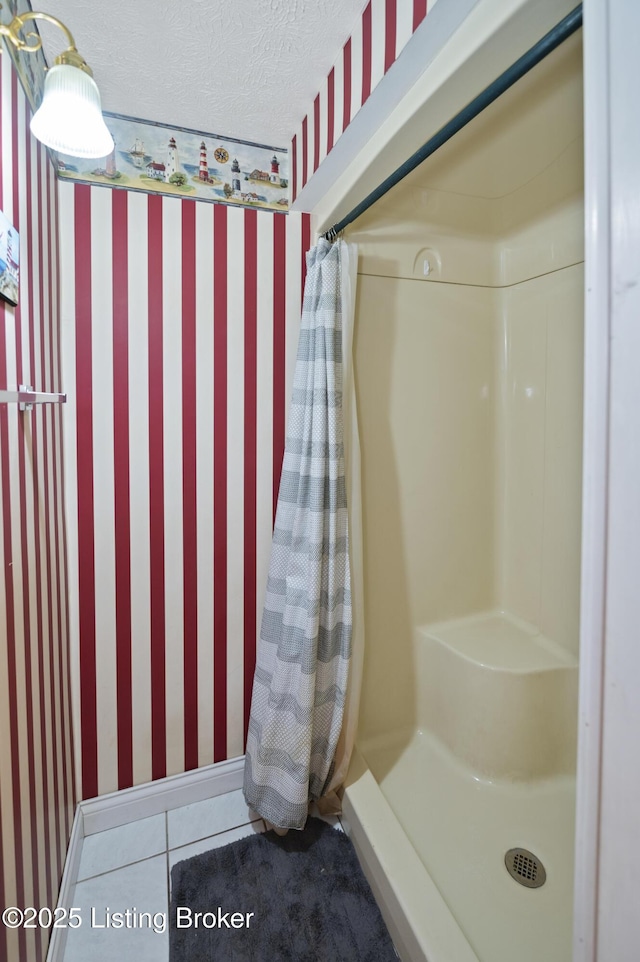 bathroom featuring tile patterned flooring, wallpapered walls, and a shower with shower curtain