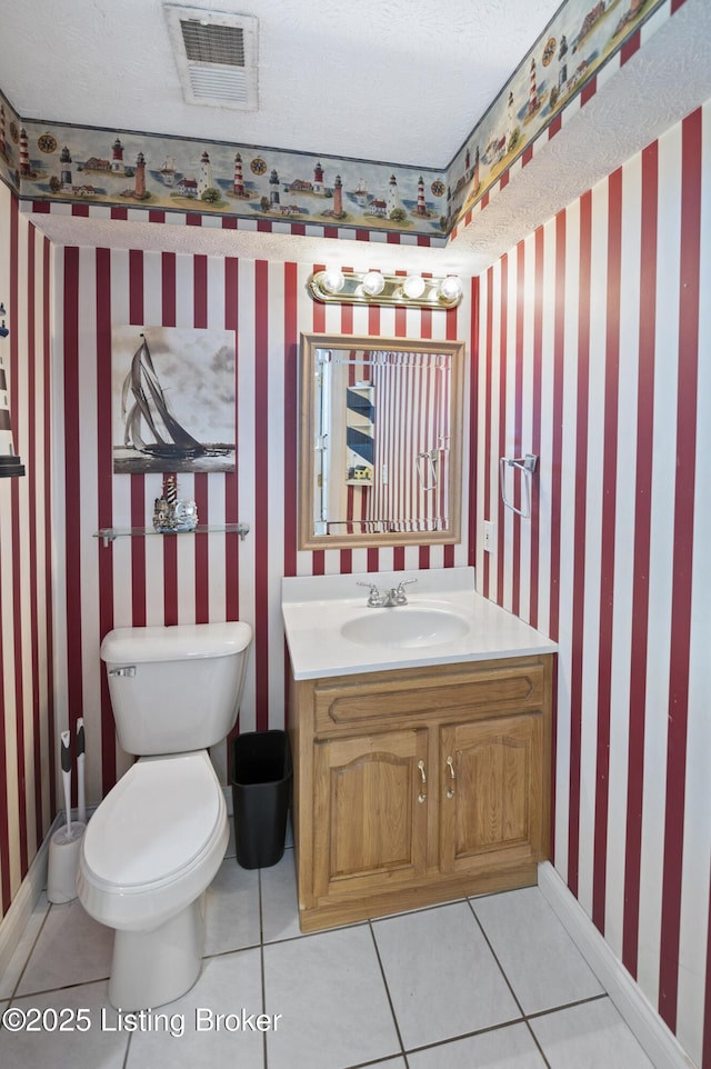 bathroom with visible vents, toilet, wallpapered walls, and vanity