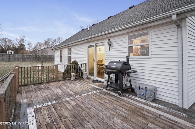 wooden deck with a grill and fence