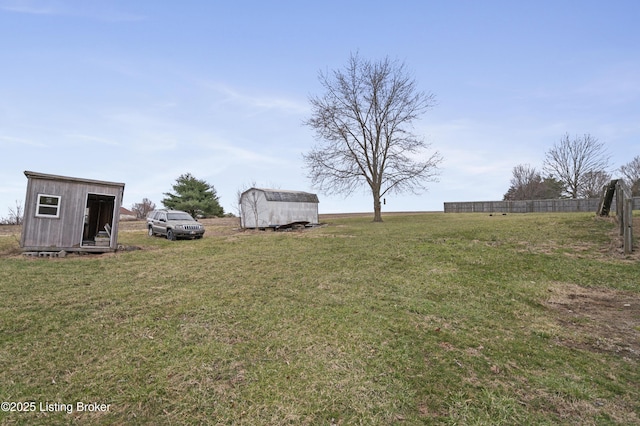 view of yard featuring an outdoor structure and a shed