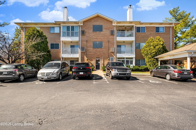 view of building exterior featuring uncovered parking