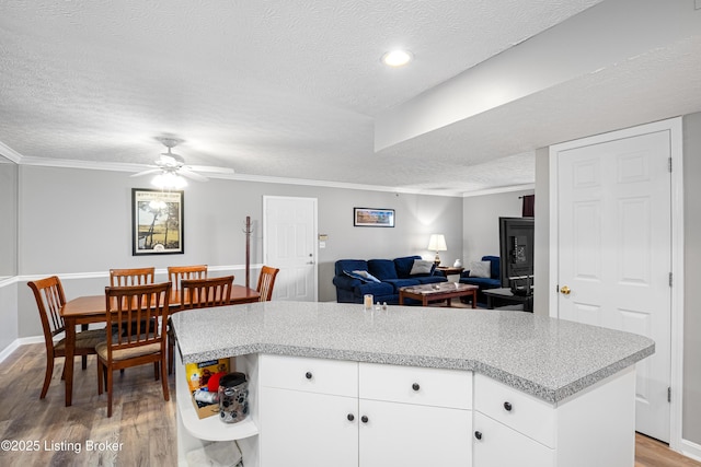 kitchen featuring light countertops, light wood-style flooring, and a textured ceiling