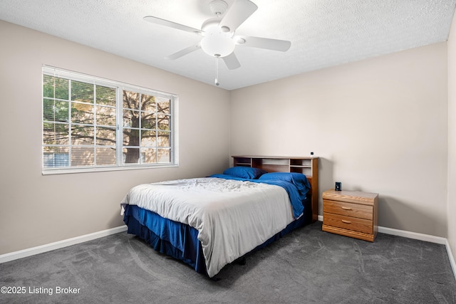 carpeted bedroom featuring a textured ceiling, baseboards, and a ceiling fan