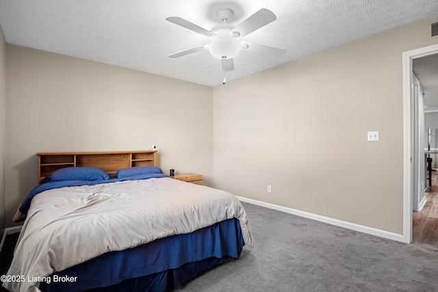 bedroom featuring visible vents, baseboards, ceiling fan, carpet flooring, and a textured ceiling