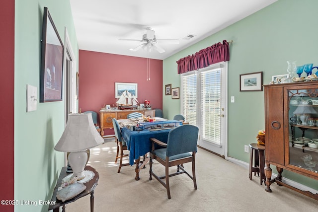 dining area with visible vents, light carpet, baseboards, and ceiling fan