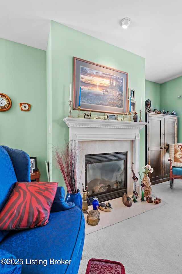 carpeted living area with a glass covered fireplace