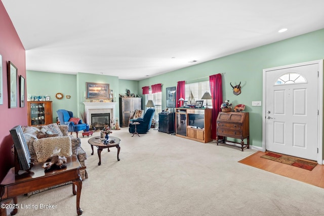 living room featuring visible vents, carpet floors, and a glass covered fireplace