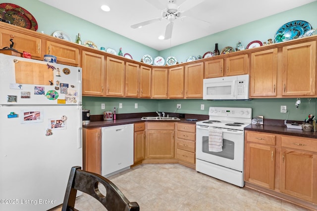 kitchen featuring ceiling fan, white appliances, dark countertops, and a sink