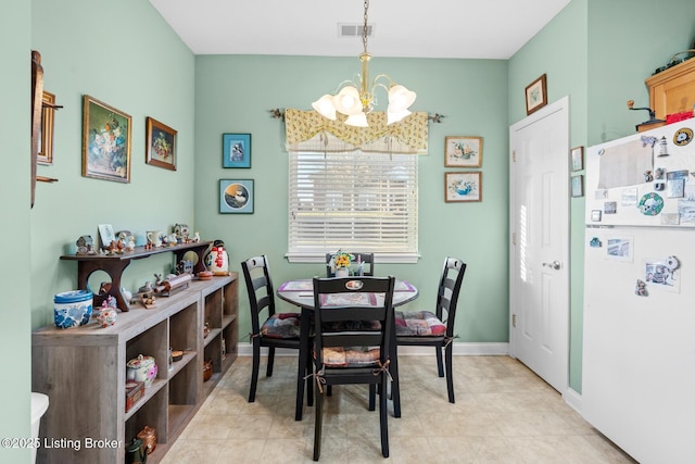 dining area featuring an inviting chandelier, baseboards, and visible vents