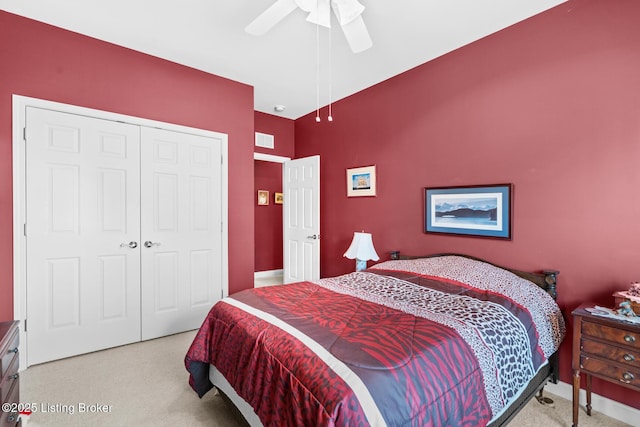 bedroom with a closet, a ceiling fan, visible vents, and carpet floors