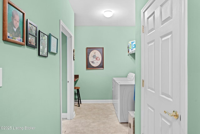 laundry area featuring laundry area, washing machine and dryer, and baseboards