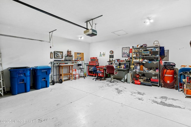 garage with a workshop area and a garage door opener