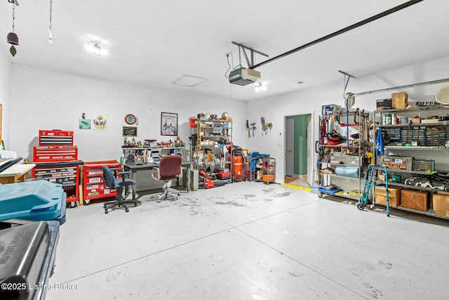 garage featuring a workshop area and a garage door opener