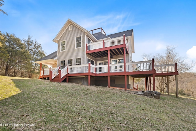 back of house featuring a wooden deck and a lawn