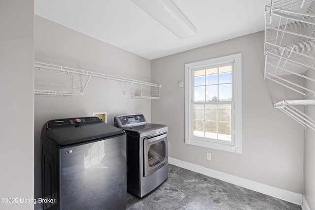 laundry room featuring washer and dryer, baseboards, and laundry area