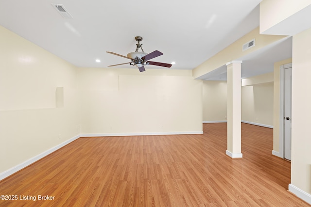 finished basement with a ceiling fan, baseboards, visible vents, and light wood finished floors