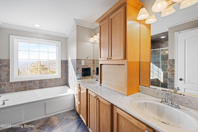 full bathroom with a sink, ornamental molding, tile patterned floors, and a bath