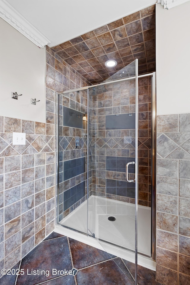 bathroom with tile walls and a stall shower