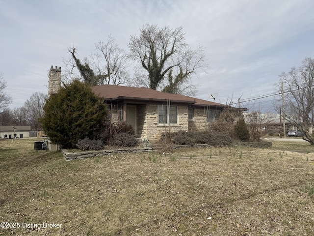 view of property exterior featuring stone siding and a chimney