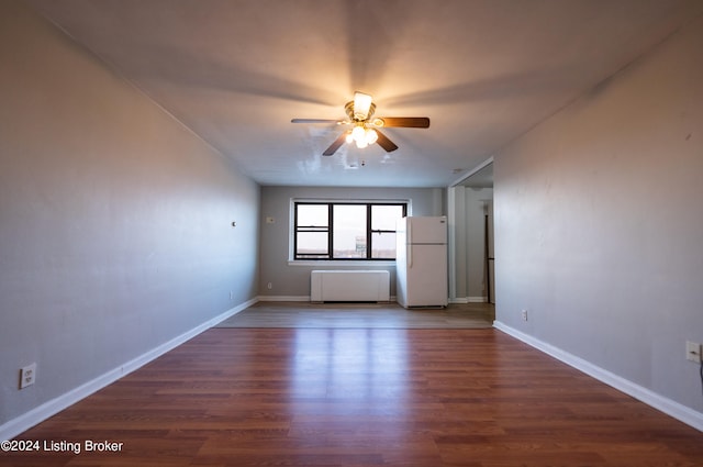 spare room with wood finished floors, baseboards, and ceiling fan