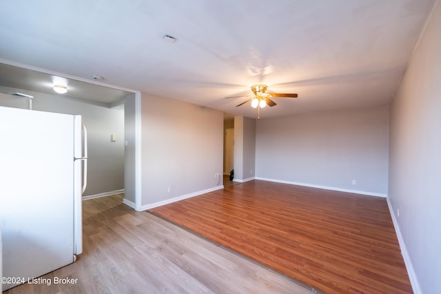 empty room with a ceiling fan, baseboards, and wood finished floors