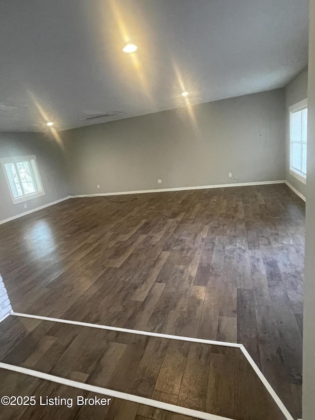 spare room featuring wood finished floors and baseboards