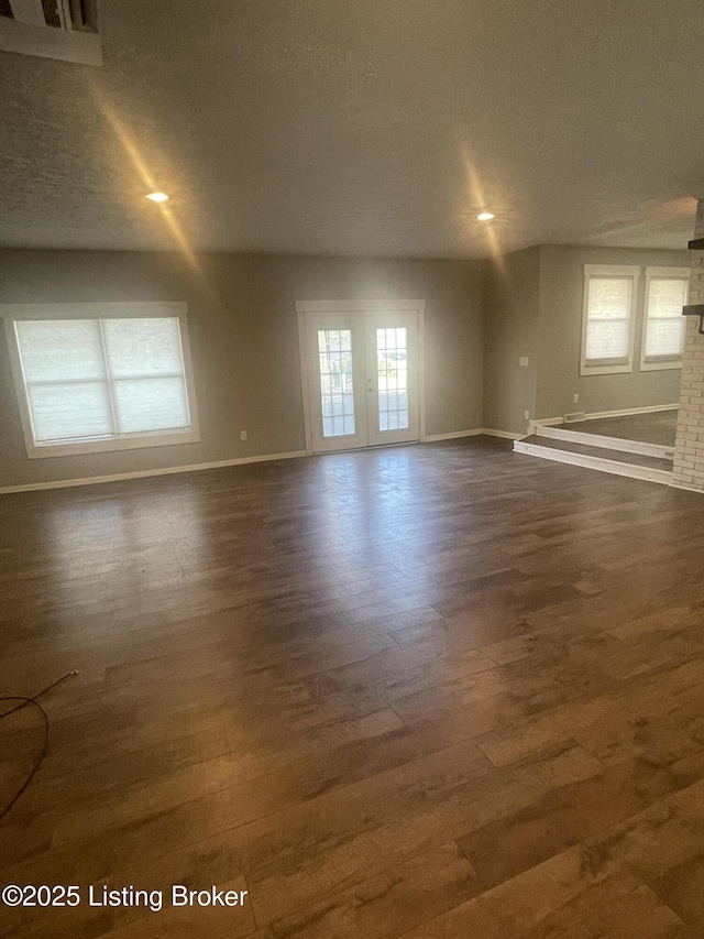 spare room featuring recessed lighting, dark wood-type flooring, and baseboards