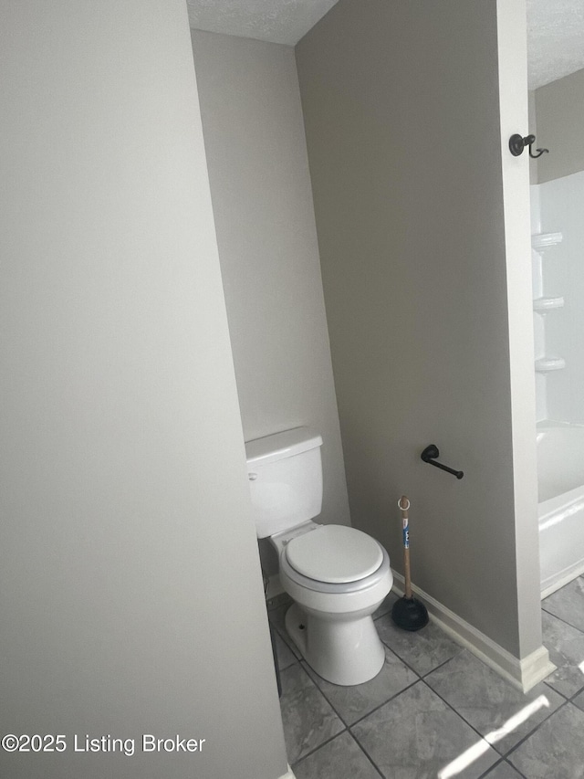 bathroom featuring  shower combination, toilet, and baseboards