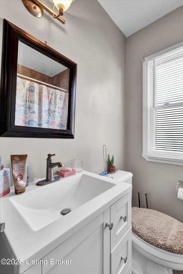 full bath with a shower with shower curtain, toilet, and vanity