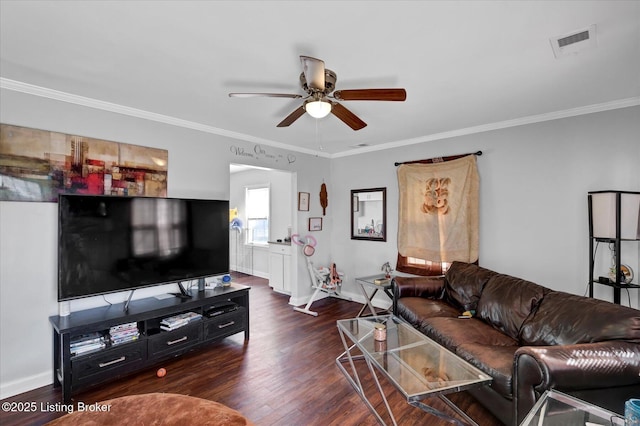 living area with visible vents, baseboards, wood finished floors, and ornamental molding