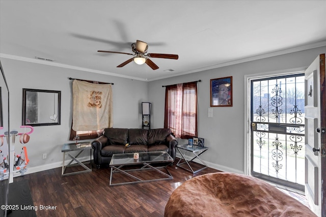 living room with visible vents, crown molding, baseboards, wood finished floors, and a ceiling fan