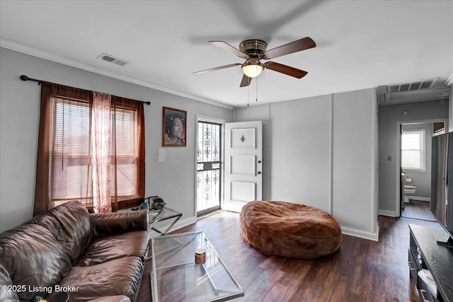 living area featuring crown molding, wood finished floors, visible vents, and ceiling fan