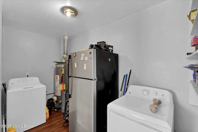 laundry room with wood finished floors, laundry area, and water heater