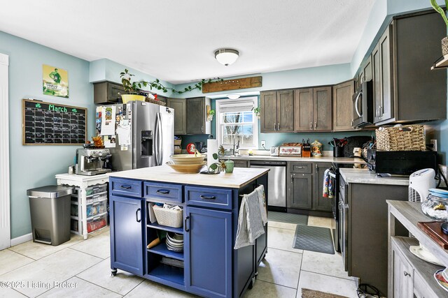 221 Forrest Dr, Lawrenceburg, KY 40342 - kitchen with stainless steel appliances, light countertops, light tile patterned flooring, and blue cabinets
