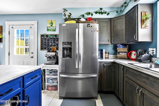 221 Forrest Dr, Lawrenceburg, KY 40342 - kitchen featuring stainless steel fridge with ice dispenser, light countertops, blue cabinetry, and dark brown cabinetry