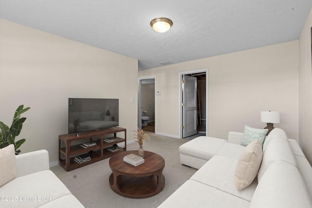 carpeted living room with visible vents, baseboards, and a textured ceiling