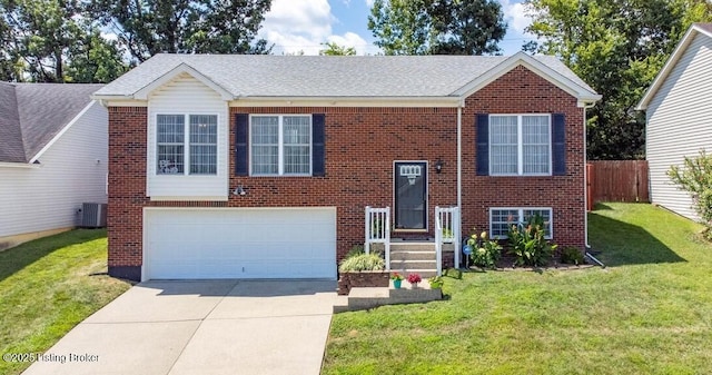 raised ranch with brick siding, concrete driveway, a garage, and a front yard