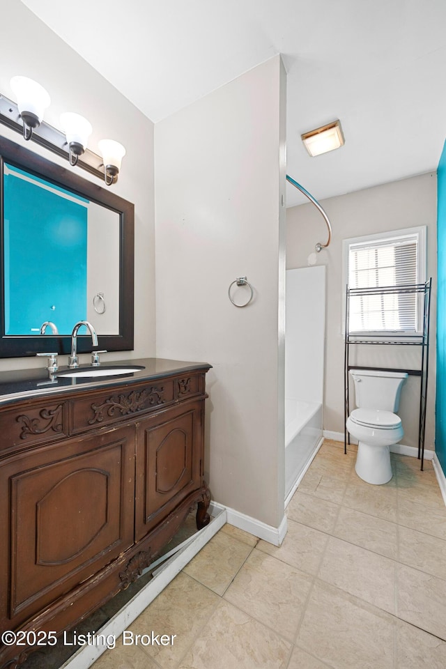 bathroom featuring baseboards, shower / washtub combination, vanity, and toilet