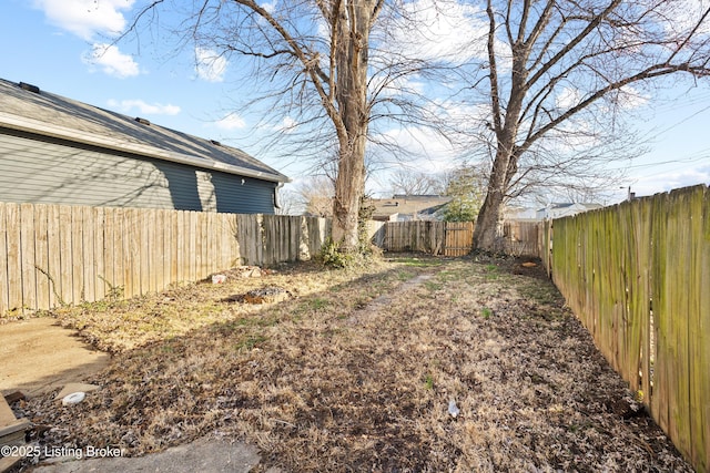 view of yard with a fenced backyard